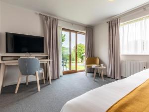 ein Hotelzimmer mit einem Bett und einem TV in der Unterkunft 2 Bed in St. Mellion 87704 in St Mellion