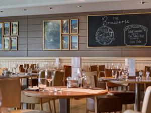 a restaurant with wooden tables and chairs and a chalkboard at 2 Bed in St. Mellion 87704 in St Mellion