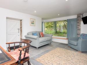 a living room with a couch and chairs and a window at 2 bed in Cowbridge 88000 