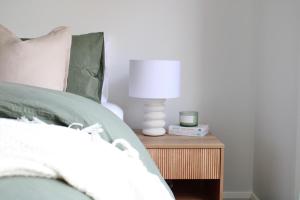 a bed with a white lamp on a night stand at The McKinlay Echuca in Echuca