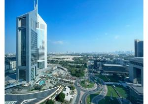 an aerial view of a city with a tall building at Amazing 3BR Apartment next to Emirates Towers Metro in DIFC in Dubai