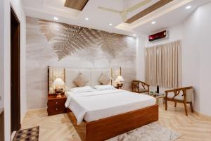 Schlafzimmer mit einem großen weißen Bett und einem Schreibtisch in der Unterkunft Avanti Tenantry- Gurugram in Gurgaon