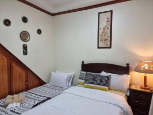 1 dormitorio con 2 camas y lámpara en The Wagner Country Homes, en Baguio