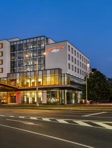 a building with a sign on the side of a street at Vienna House Easy by Wyndham Pilsen in Plzeň