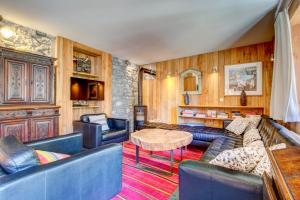 a living room with blue couches and a table at Auberge RDC in Morzine