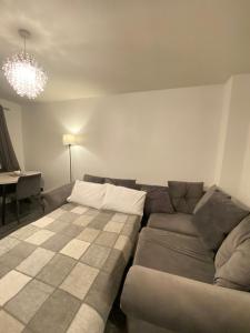 a living room with a couch and a table at Cosy Apartment Near Bluewater With Private Parking in Kent