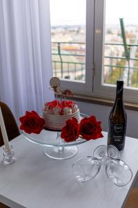 a table with a cake and a bottle of wine at Nel Cuore di Parthenope in Naples