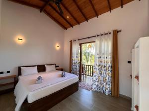 Ένα ή περισσότερα κρεβάτια σε δωμάτιο στο The Point Mirissa