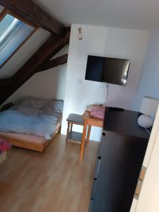 a small bedroom with a bed and a desk at Gasthaus Sunnenhof Sonne 