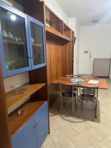a kitchen with a table and chairs in a room at Residenza Adelaide 2 in Finale Ligure