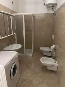 a bathroom with two toilets and a sink and a shower at Residenza Adelaide 2 in Finale Ligure