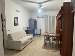 a living room with a couch and a table at Residenza Adelaide 2 in Finale Ligure