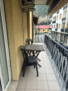 a table and chairs on the balcony of a building at Residenza Adelaide 2 in Finale Ligure