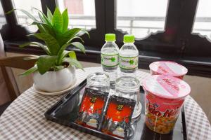 a tray with four bottles of drinks on a table at KLy Hotel in Hue