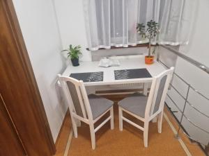 uma pequena mesa branca e cadeiras num quarto em Noclegi Budomas Budget FreeParking, Free Netflix, Free Youtube Premium em Breslávia