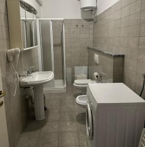 a bathroom with a sink and a toilet and a shower at Residenza Adelaide 2 in Finale Ligure