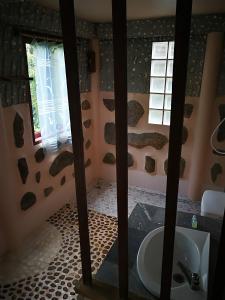 a bathroom with a sink and a toilet in a room at Smile Bungalow Bottle Beach in Bottle Beach