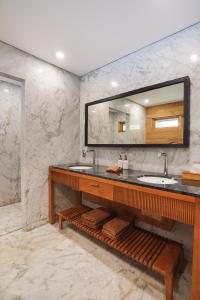 a bathroom with a sink and a mirror at Sunset Ubud Estate with Ricefield views - RUSTERS Villa Estate in Ubud