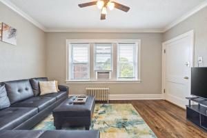 a living room with a couch and a ceiling fan at Rustic APT Near Hosp 25mins to ORD, MDW, DT in Berwyn