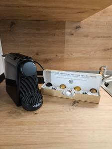 a box of donuts sitting on the floor next to a toaster at Malina Glamping in Vama