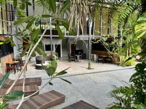 a courtyard with tables and chairs in a building at aonangstudio in Krabi town