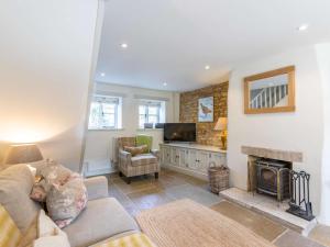 a living room with a couch and a fireplace at 2 Bed in Bourton-on-the-Water 28292 in Bourton on the Water