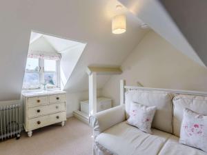 a living room with a white couch and a window at 2 Bed in Bourton-on-the-Water 28292 in Bourton on the Water