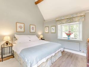 a bedroom with a large bed and a window at 1 Bed in Sherborne 89082 in Sherbourne