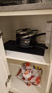 a pot sitting on a shelf in a kitchen at London Spacious Apartment in Brentford