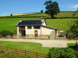 a house with solar panels on it in a field at 2 Bed in South Molton 88992 in Bishops Nympton