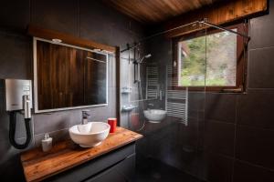 a bathroom with two sinks and a glass shower at Le refuge du peintre in Gérardmer +34 photos