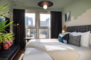 a bedroom with a bed and a large window at Les Artistes in Paris