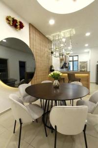 una sala da pranzo con un tavolo e sedie bianche di Unique 3 Storey Near Jonker@Heritage (max 25pax) a Malacca