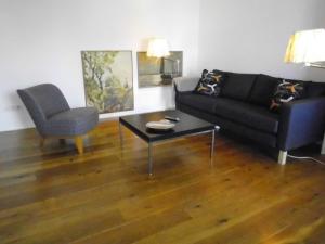 a living room with a couch and a table and a chair at Susanne Hendus in Neustadt in Holstein