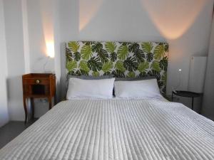 a bedroom with a large bed with a large headboard at Susanne Hendus in Neustadt in Holstein