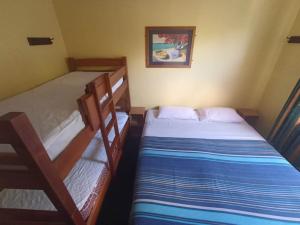 a bedroom with two bunk beds in a room at Rotorua Central Backpackers in Rotorua