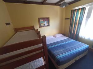 a bedroom with two bunk beds and a window at Rotorua Central Backpackers in Rotorua