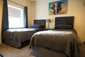 a bedroom with two beds and a window at COZY PLACE LIVERPOOL in Liverpool