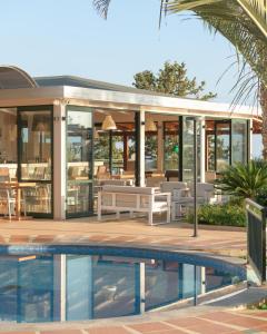 a villa with a swimming pool and a house at Asterias Village in Hersonissos
