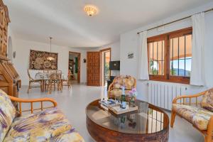 a living room with a table and chairs at Olivo in Jávea