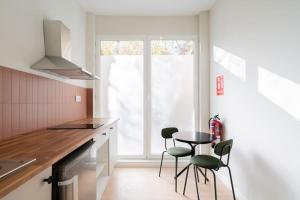 a kitchen with a table and chairs and a window at Nice studio in Madrid-Fp02 in Madrid