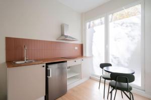 a kitchen with a table and chairs and a window at Nice studio in Madrid-Fp02 in Madrid