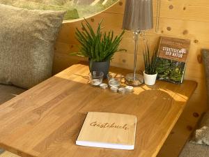 a wooden coffee table with a christmas sign on it at Zinipi Retreat Mohrenhof in Geslau