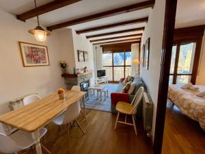 een keuken en een woonkamer met een tafel en een bank bij C18 - Alojamiento Mirador de Cerler - Villmor in Cerler