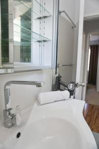 a bathroom with a sink and a mirror at Comfortconvenience 2-bedroom Unit For Families in Perth