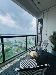a balcony with a table and chairs and a view at R&F PRINCESS COVE at ANJU in Johor Bahru