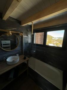 a bathroom with a sink and a mirror and a window at Appartement le StelO Les Gets 6 personnes aux pieds des pistes 2 chambres in Les Gets