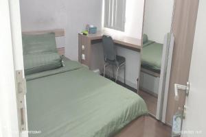 Postel nebo postele na pokoji v ubytování Barata Residence Aeropolis