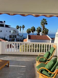 a balcony with chairs and the ocean in the background at Ocean View near the Beach in Adeje