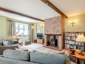 a living room with a couch and a fireplace at 2 Bed in Reepham 37016 in Cawston